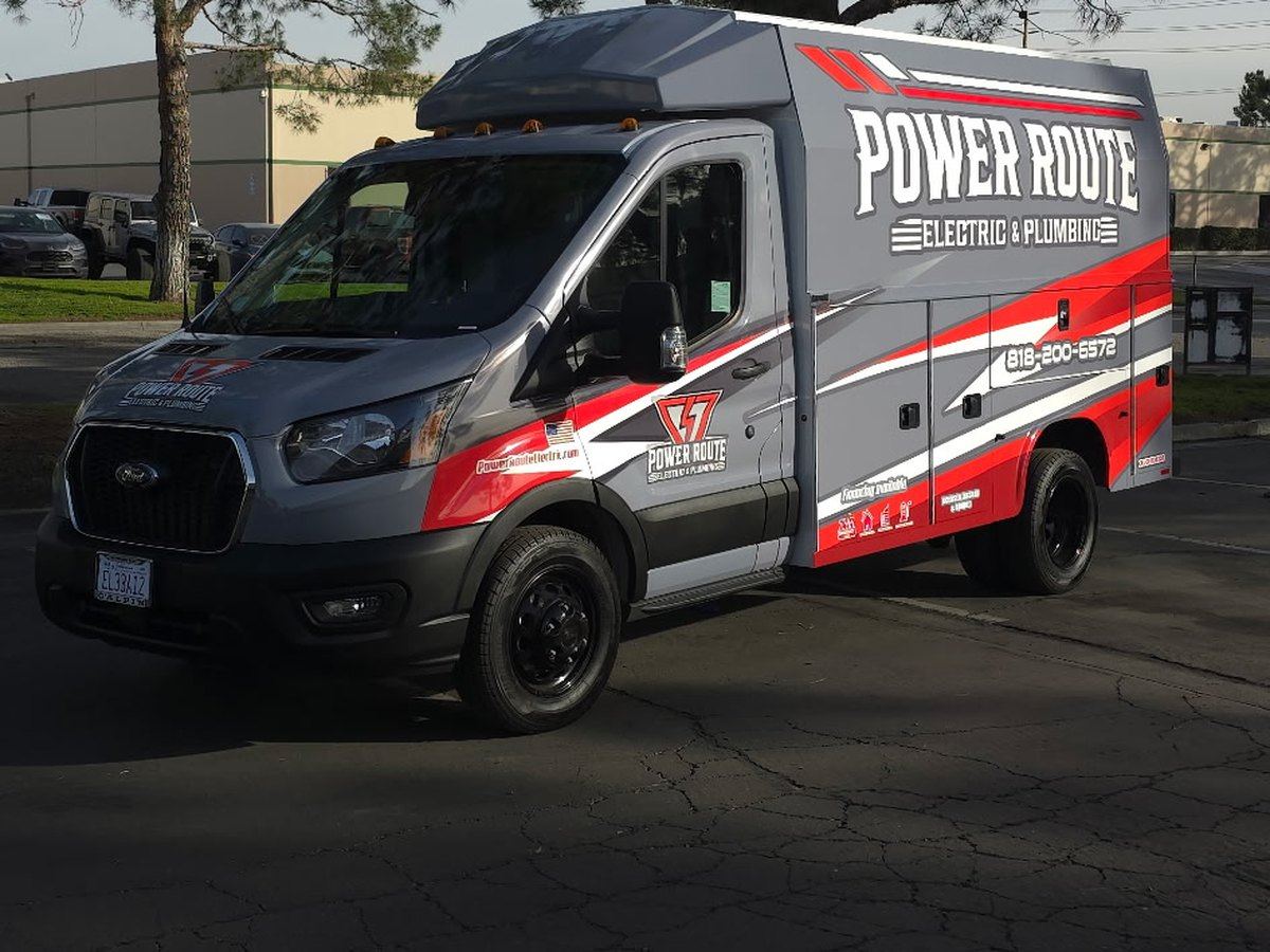 A Power Route Electric and Plumbing service van parked on a job in Los Angeles.